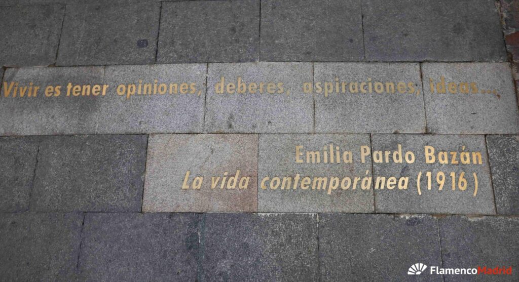 Calle empedrada del Barrio de las Letras en Madrid con uno de los famosos versos dorados en el suelo.
